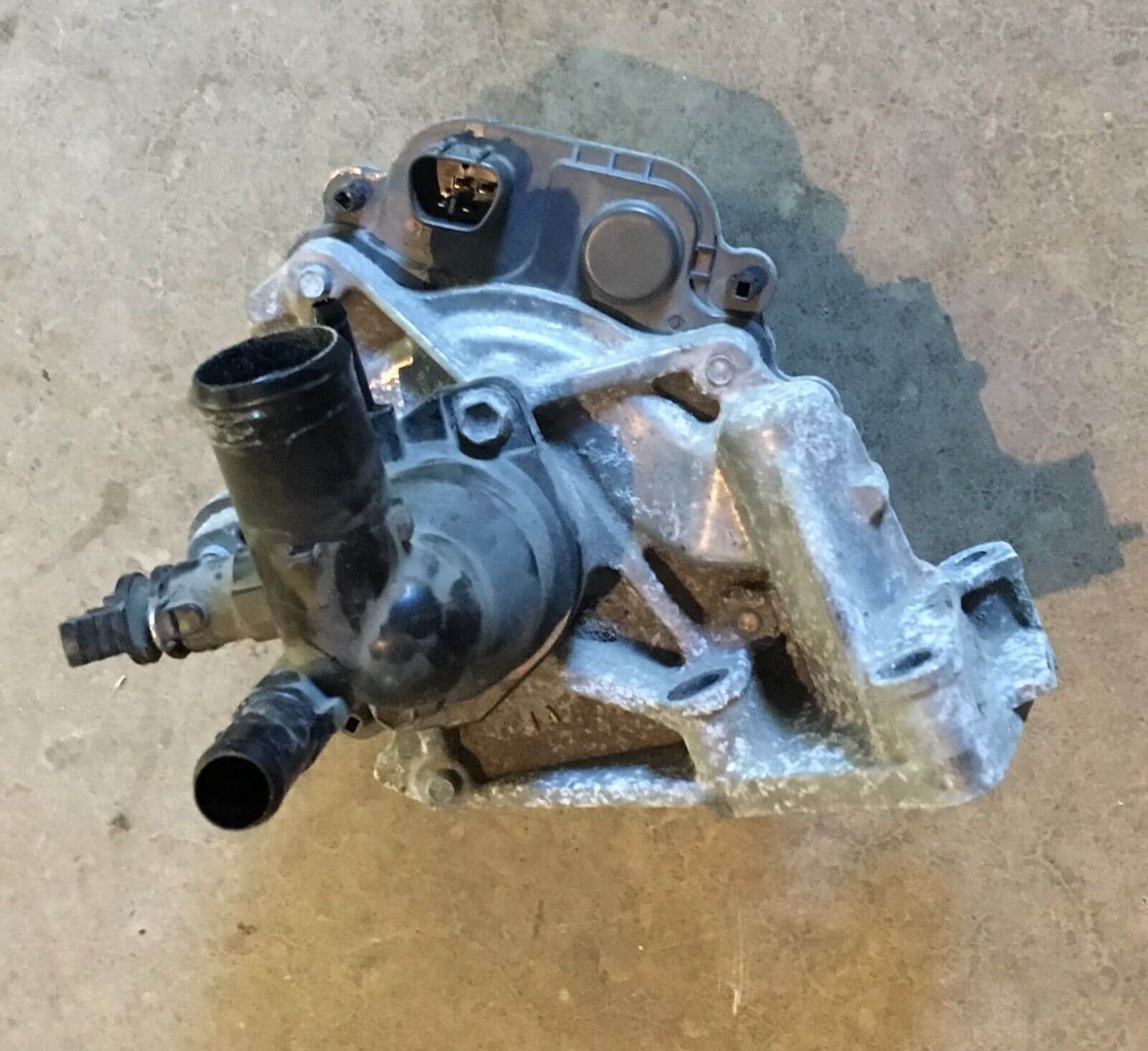2012-2014 Toyota Prius C 1.5L Water Pump W/ Coolant Thermostat Housing used OEM part in excellent condition